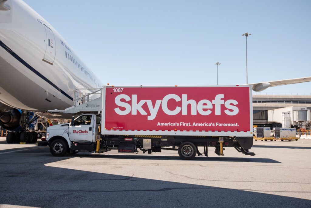 A SkyChefs truck pulls up to an aircraft prior to catering the flight.